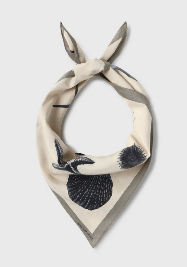 Necklace with shell and seashell design on a beige background