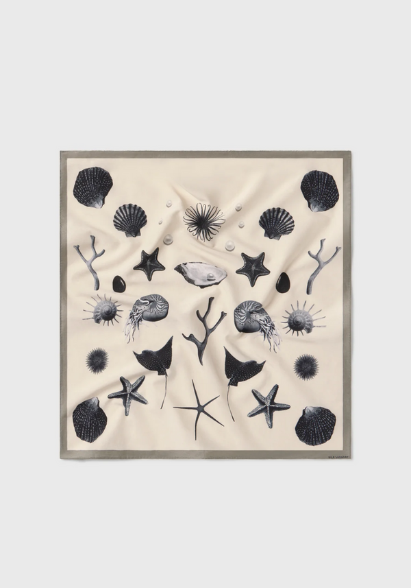 Beige scarf with black sea-themed pattern on a white background