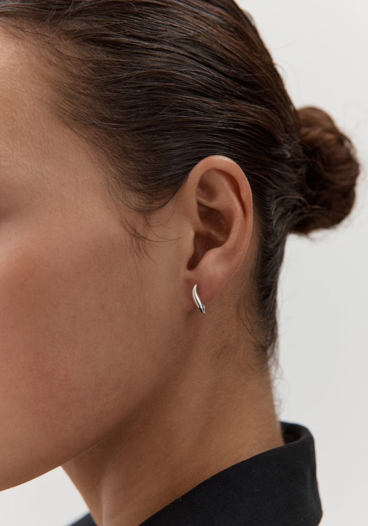 Nina Gordon Debut Hoops Silver worn on model's ear, close up