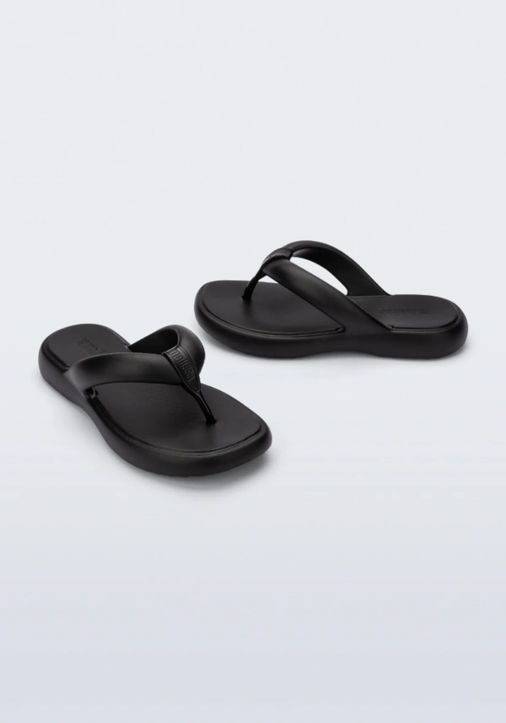 Pair of black sandals on a light gray background